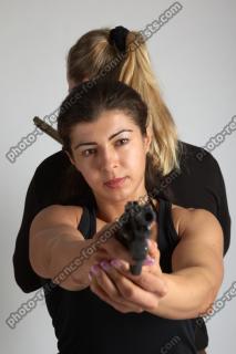 OXANA AND XENIA STANDING POSE WITH GUNS 4